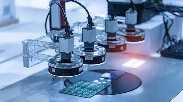 Multi-camera vision inspection station scanning electronics on a production line